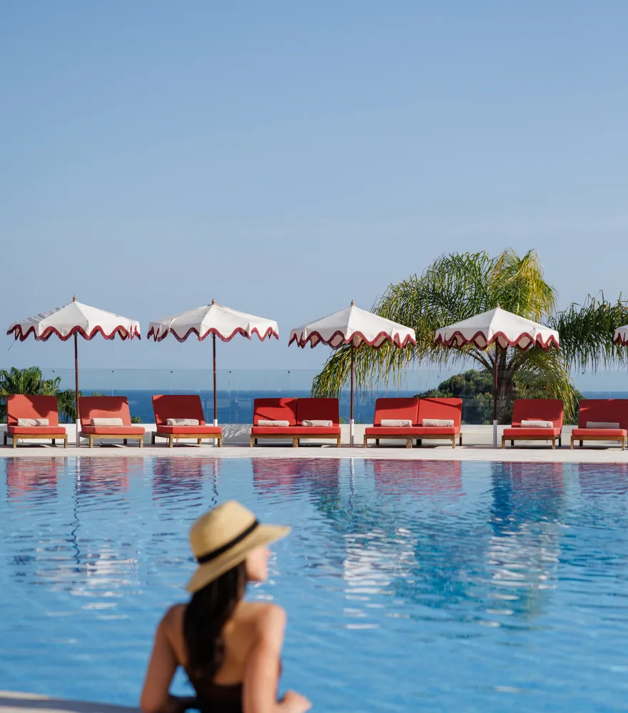 A guest by the pool in the morning sun