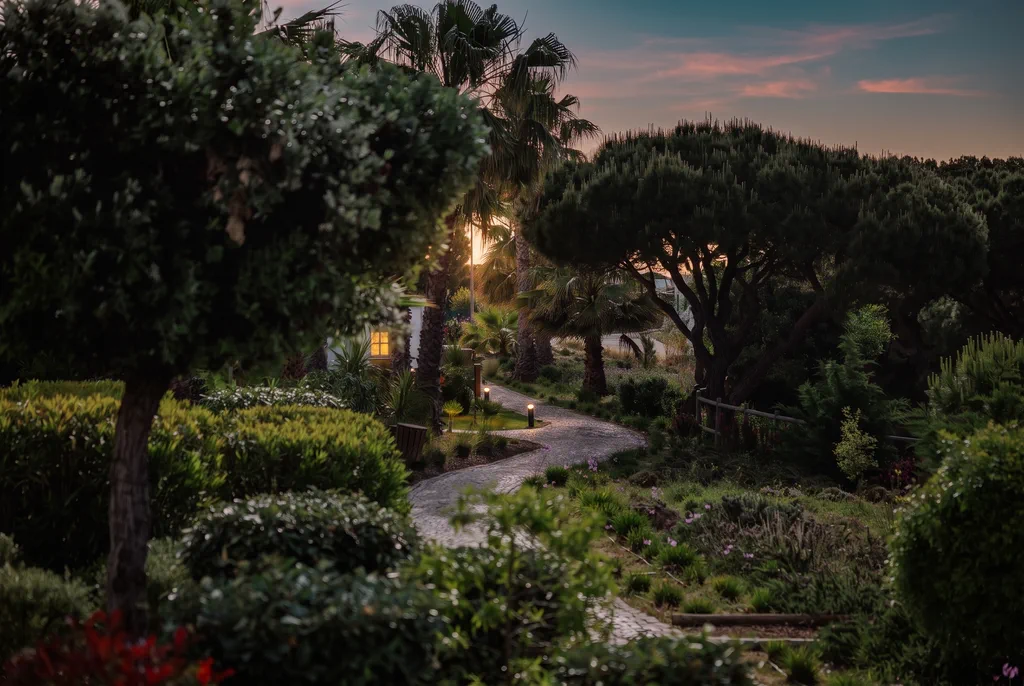 The garden path at Masana at dusk, its lamps lit